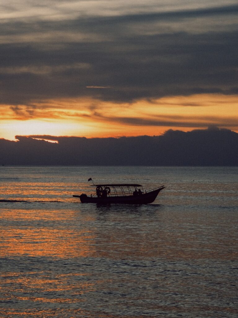 A small boat in the middle of a large body of water