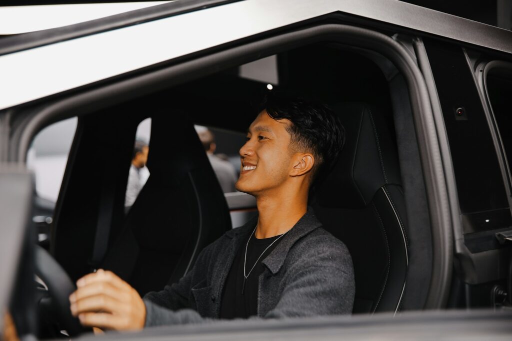 A man sitting in the driver's seat of a car