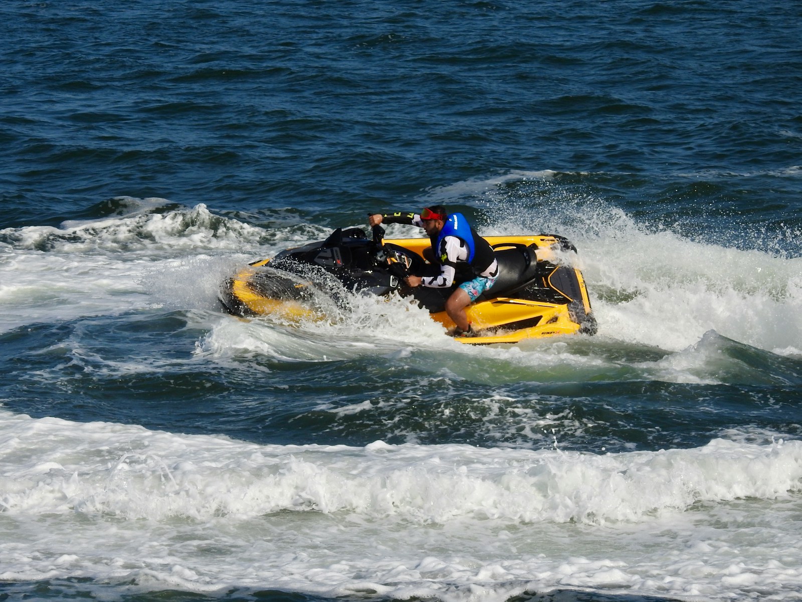yellow and black personal watercraft on sea waves during daytime