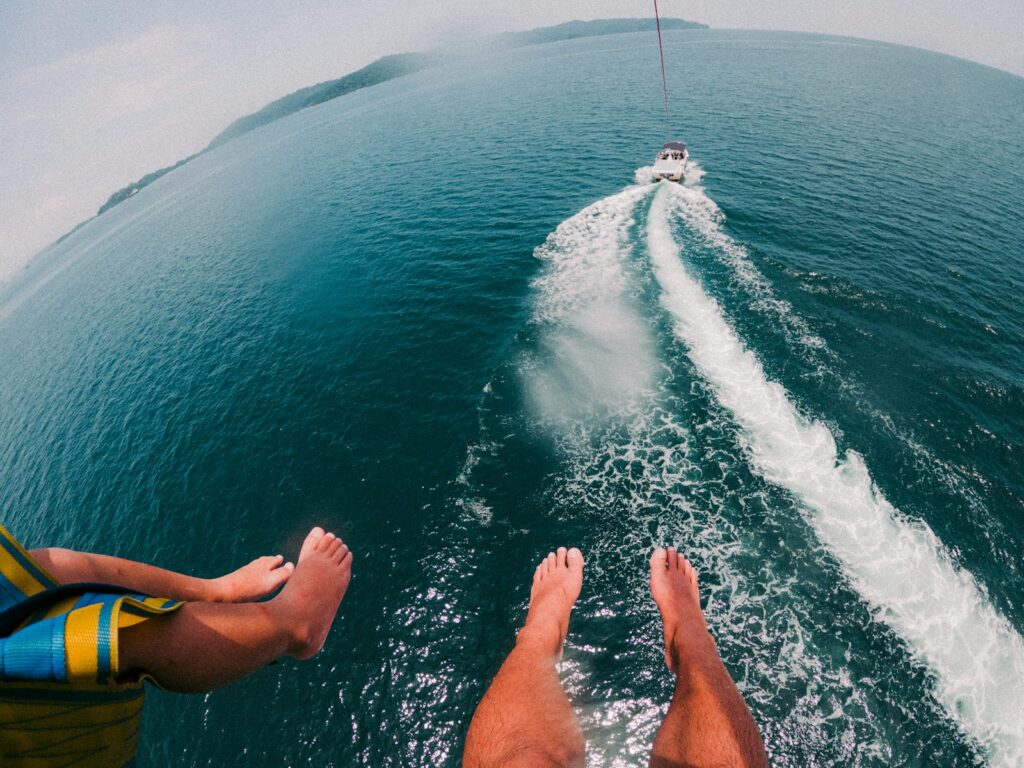 a man riding a jet ski while being pulled by a boat