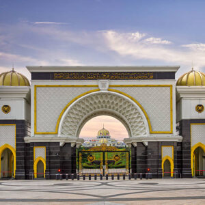 Kuala Lumpur, Malaysia - February 19, 2025: The grand entrance of Istana Negara stands majestically against a colorful sunset. This royal palace represents Malaysia's cultural heritage