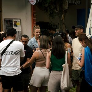 a group of people standing around each other