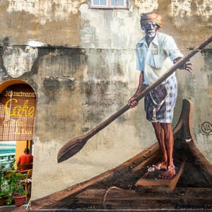 George Town, Malaysia - October 24, 2015: Street art painting of elderly man with oar in boat by Ernest Zacharevic. Street art is recongizable landmark in George town. October 2015