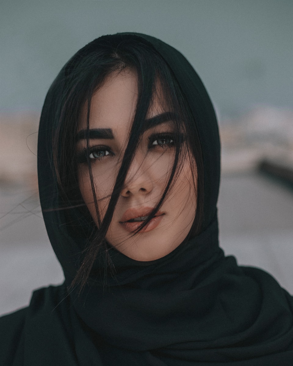woman in black hijab taking selfie