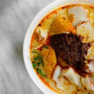 a bowl of noodles with meat and vegetables